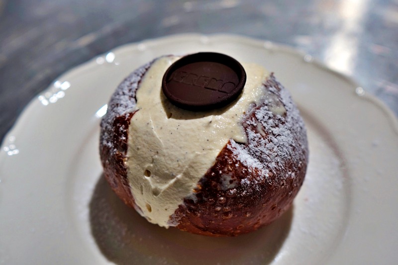 cream-filled maritozzo bun with chocolate disc at Crema